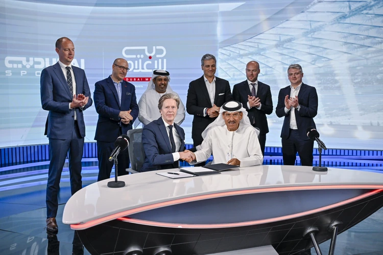 Executives signing partnership agreement in a modern TV studio, illustrating media marketing strategy and brand collaboration in the sports industry.