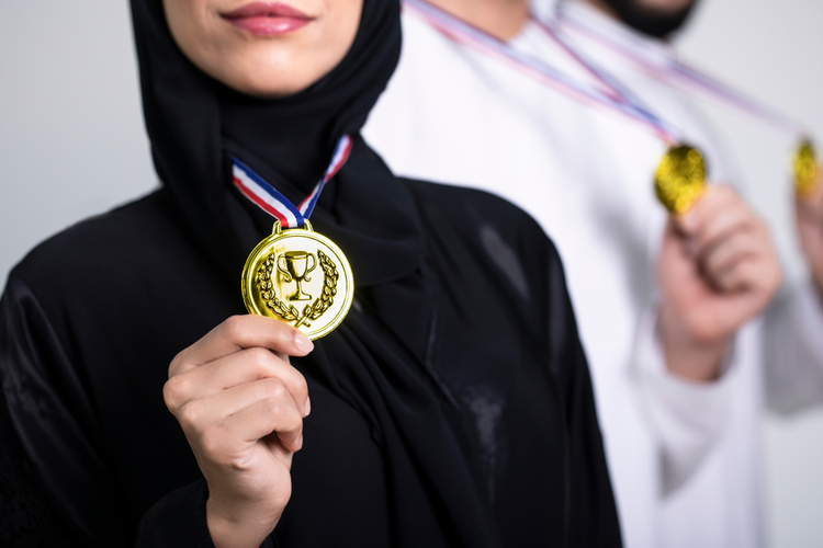 Emirati athletes proudly display gold medals, highlighting achievement and talent representation in UAE sports.