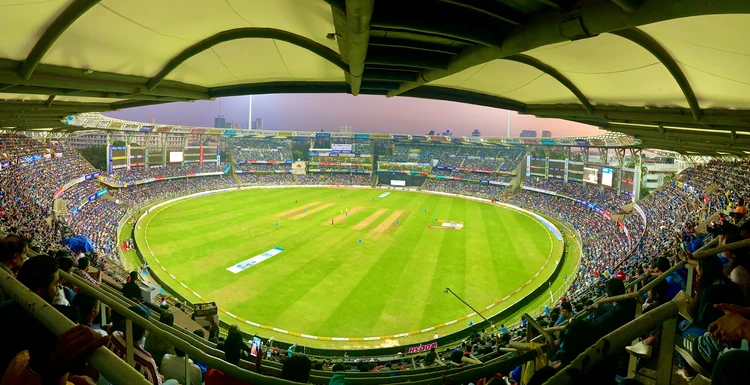 Panoramic view of a packed cricket stadium during a major match, highlighting vibrant crowd energy and prime venue for Event Sponsorships in international sports.