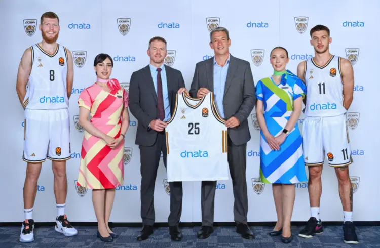 Dubai Basketball players and dnata representatives display new team jerseys during a sports marketing sponsorship launch event in Dubai, highlighting the dnata and Dubai Basketball partnership.