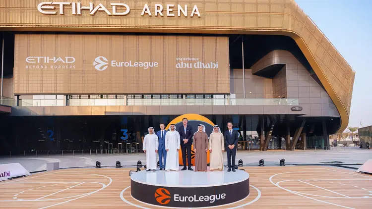Sports Marketing event at Etihad Arena, Abu Dhabi featuring EuroLeague sponsorship announcement with executives and branded signage.
