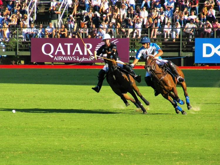 Ghantoot Polo Club players in action during a polo match, highlighting dynamic horse riding and the excitement of sports sponsorships at a major UAE event.