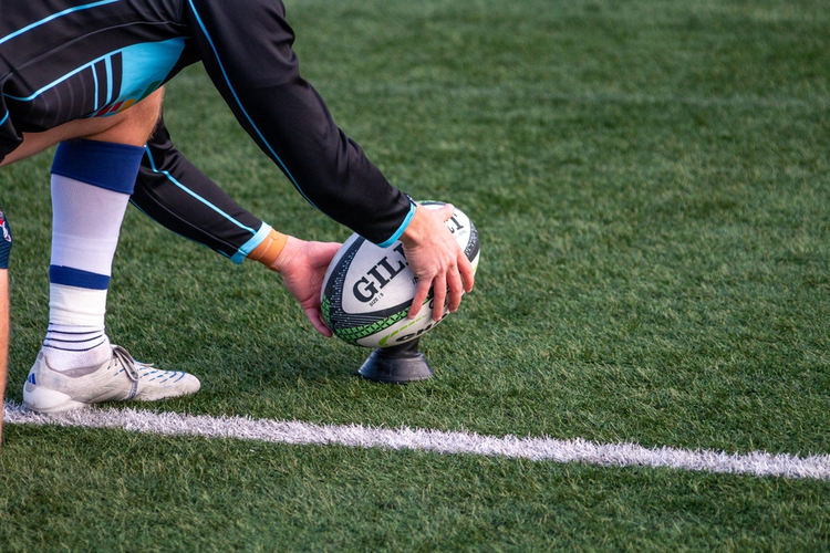 Dubai Knights rugby player in blue kit preparing a kick during training, symbolizing the StrideIT sponsorship partnership in UAE rugby.