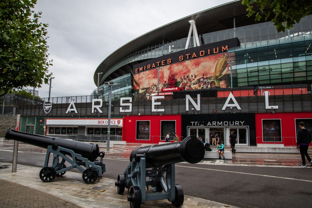 Emirates Stadium exterior in London, showcasing Arsenal and Emirates sports branding under their renewed sponsorship partnership.
