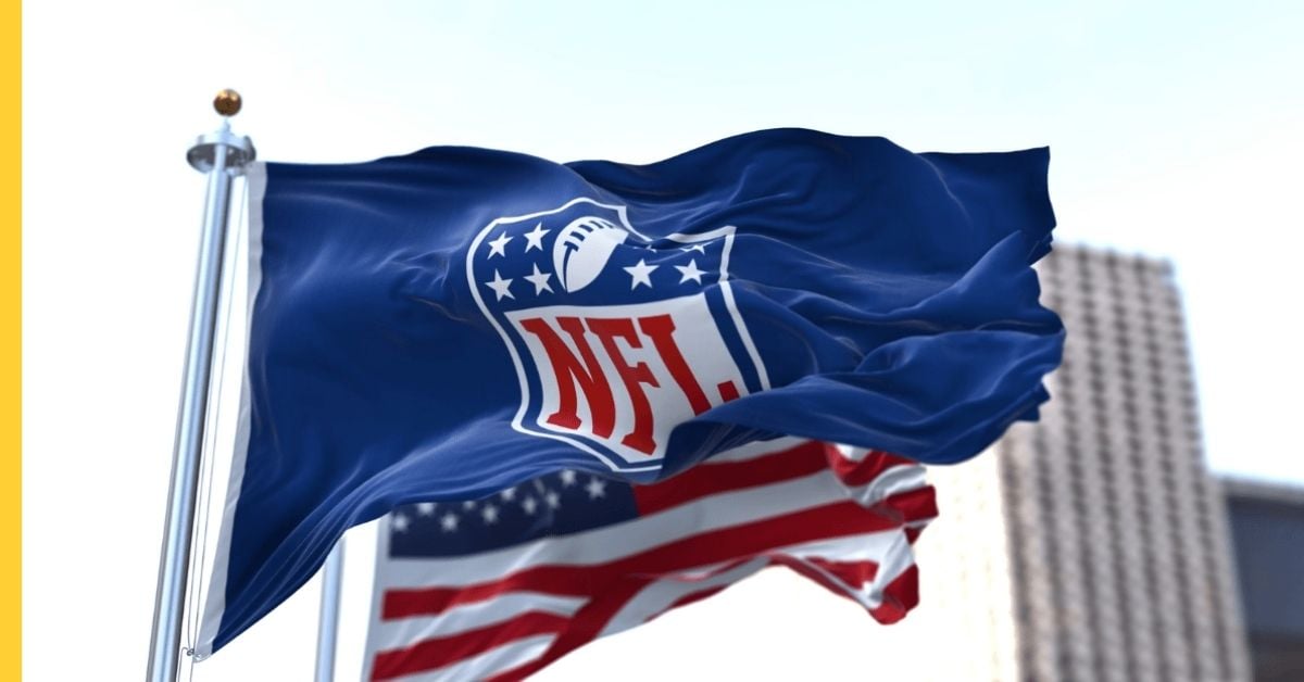NFL shield flag flying beside the US flag, as the league renews DraftKings and FanDuel and adds Fanatics in sports betting