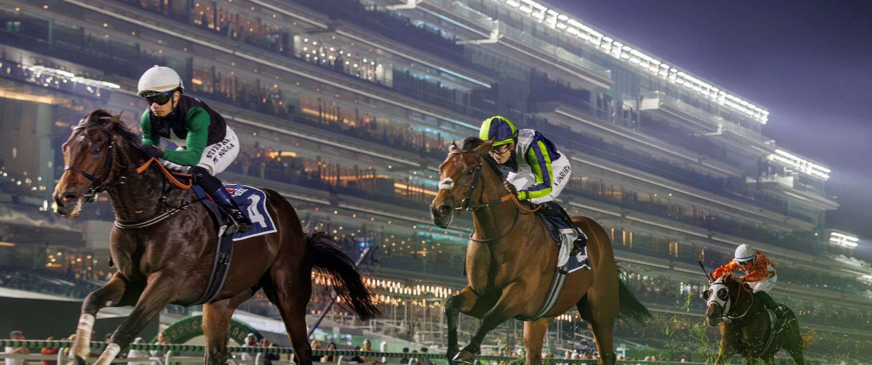 Horses racing under floodlights at Meydan Racecourse, home of the Dubai World Cup and Ticketmaster's new event sponsorship deal