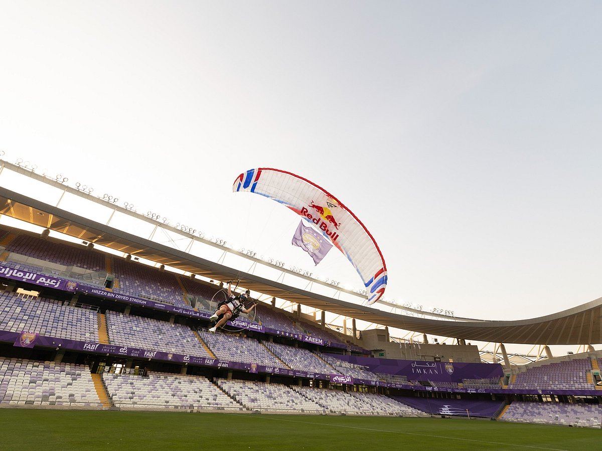 Red Bull paramotor pilot flying over the pitch at Al Ain's Hazza bin Zayed Stadium to launch the club's sports sponsorship partnership