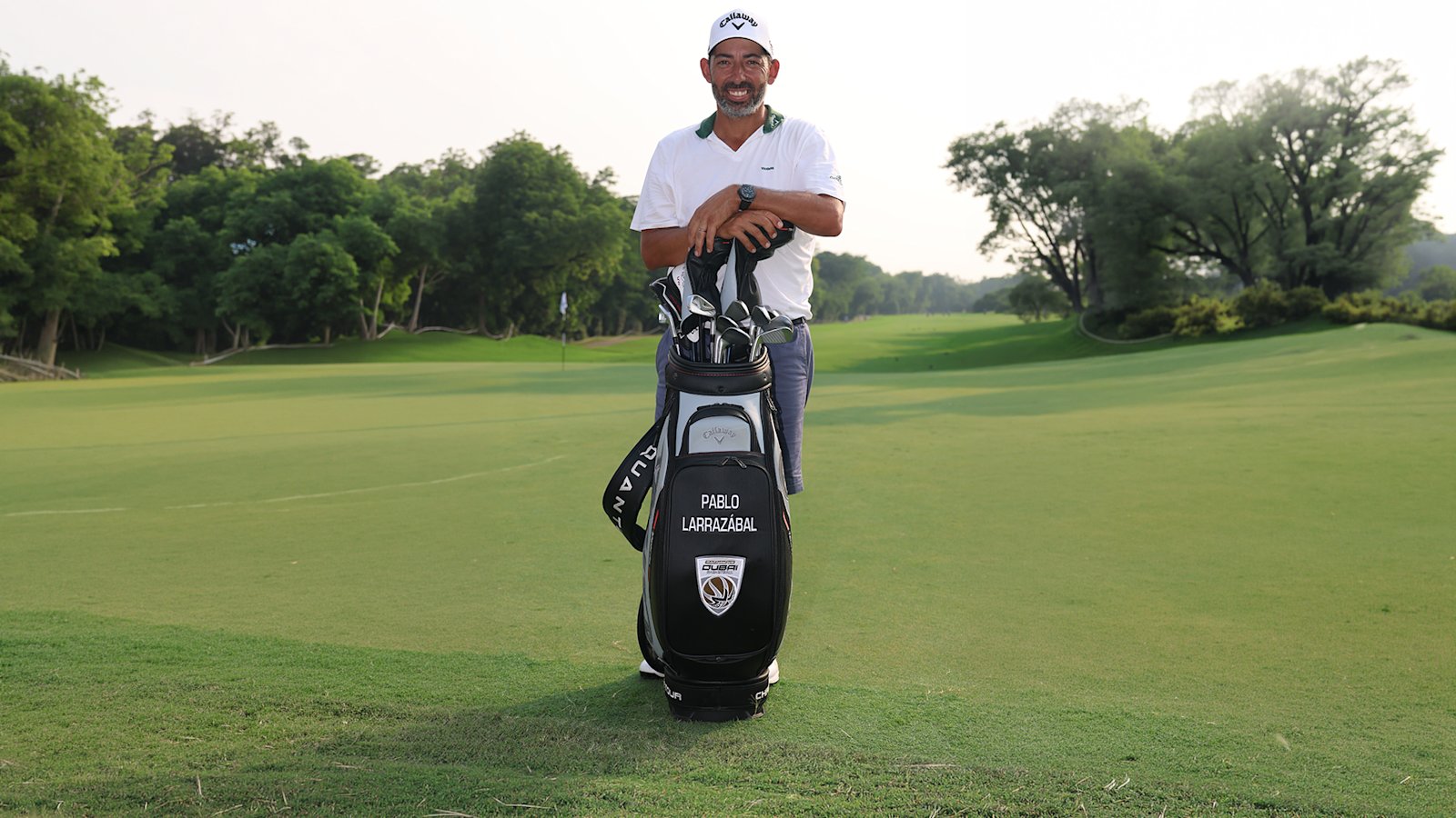 Pablo Larrazábal on a golf course with a Dubai Basketball crested golf bag, marking his ambassador role in a talent representation deal