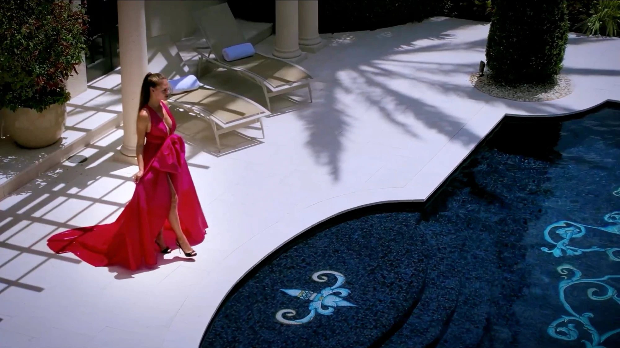 Mosaicist: woman in a red gown beside a mosaic pool