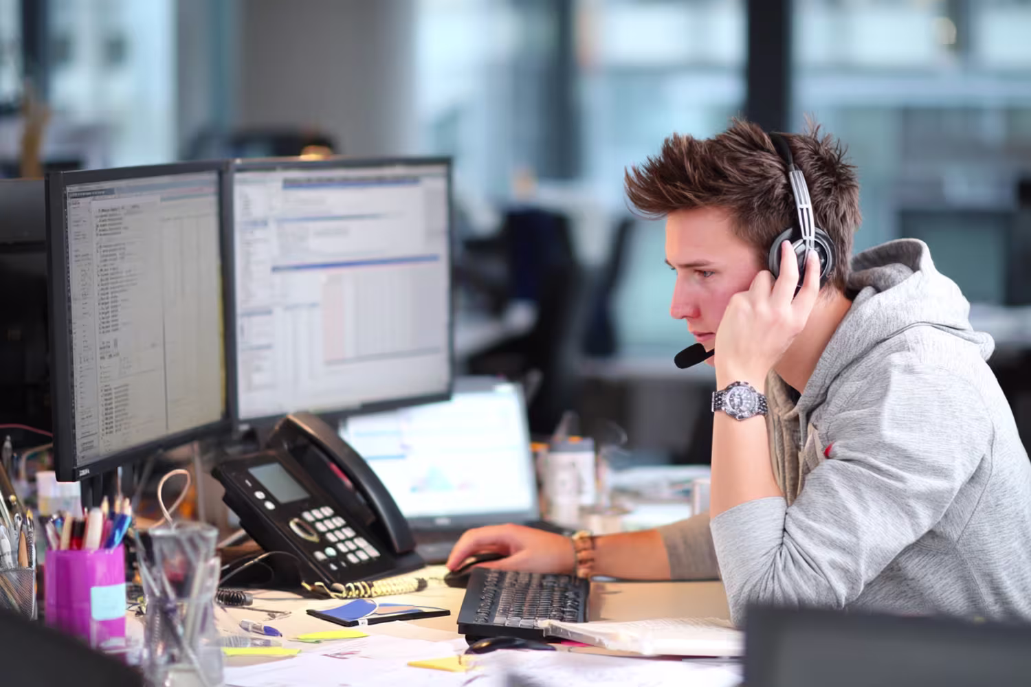 IT professional multitasking at desk