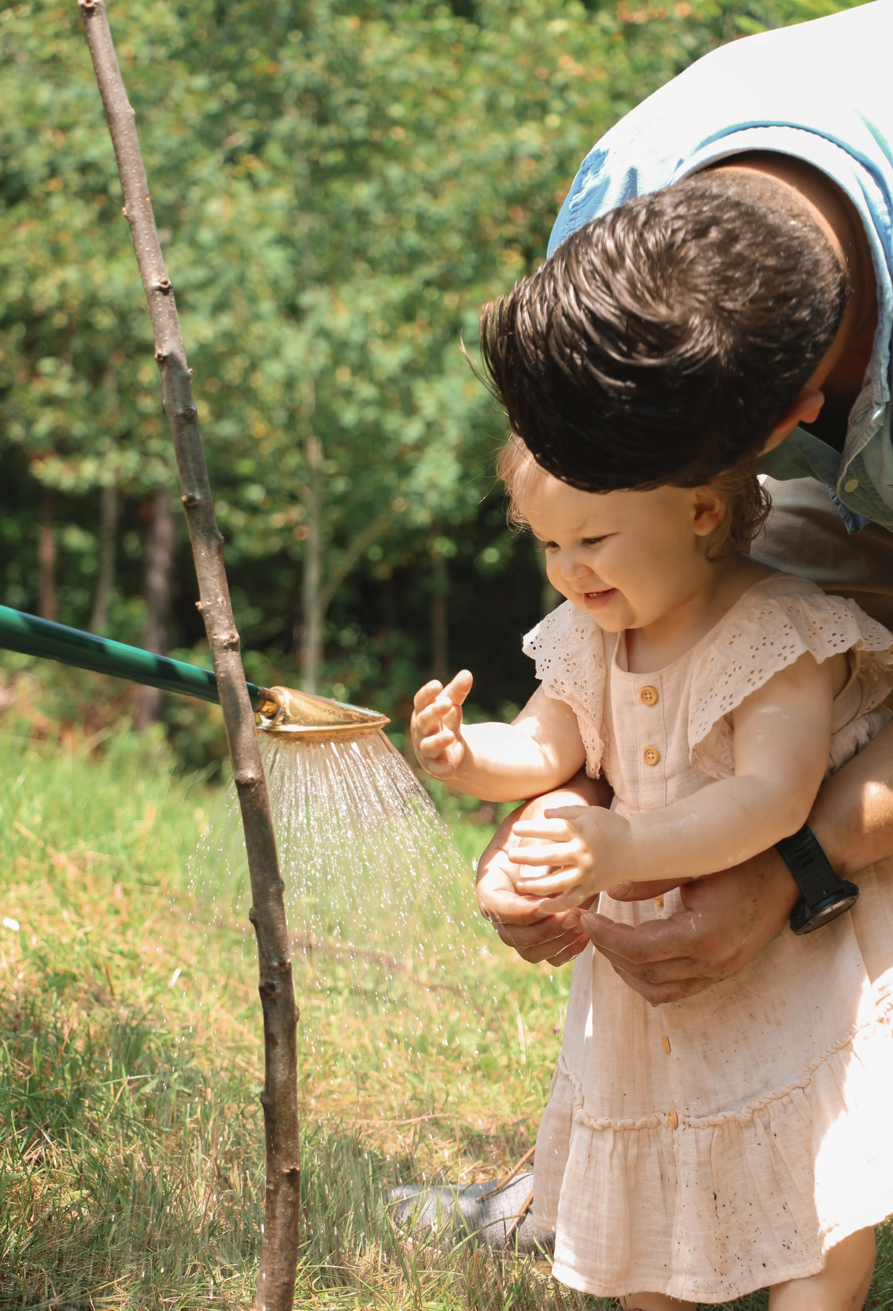 Photo of a child and his father planting a tree