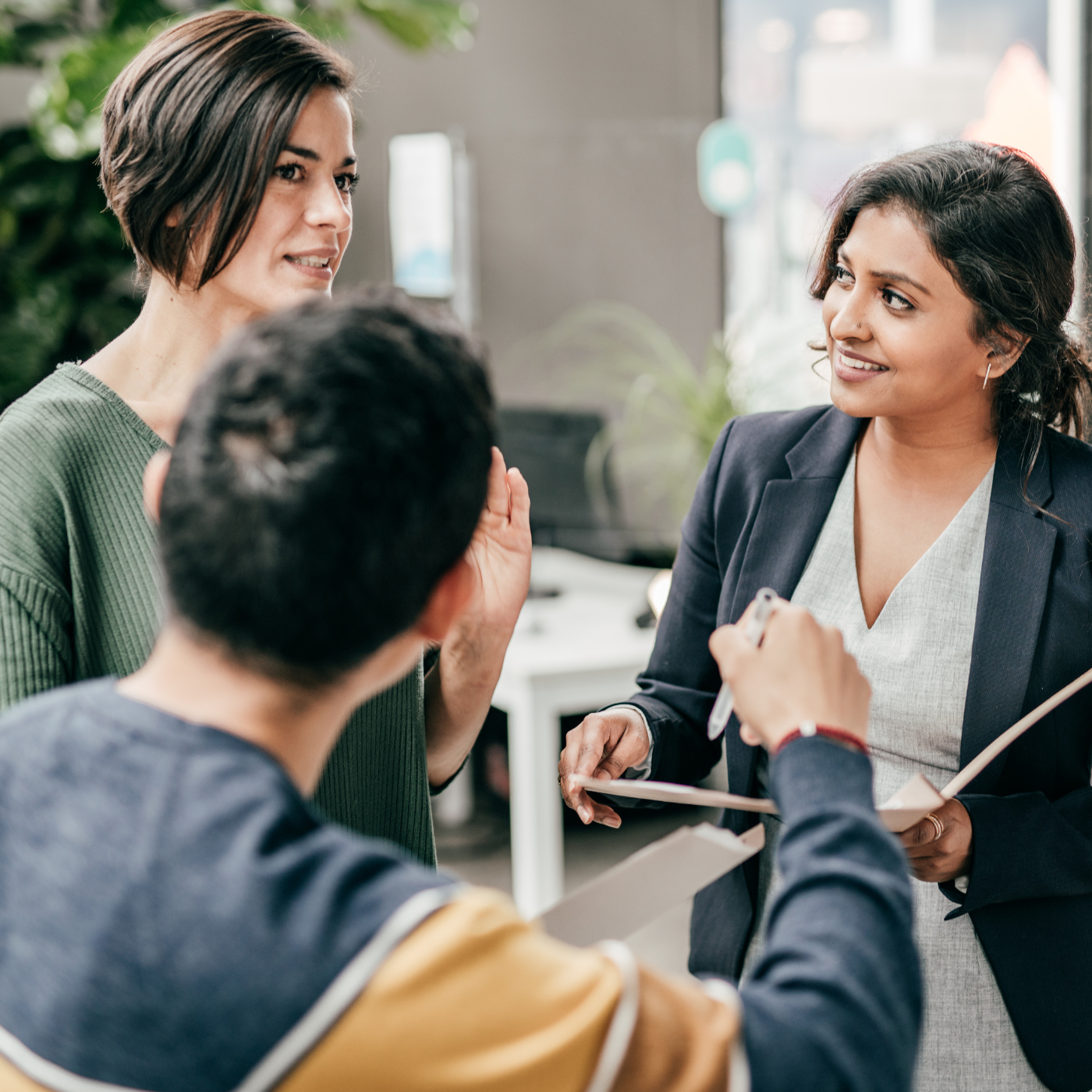 Three happy business people discussing strategy