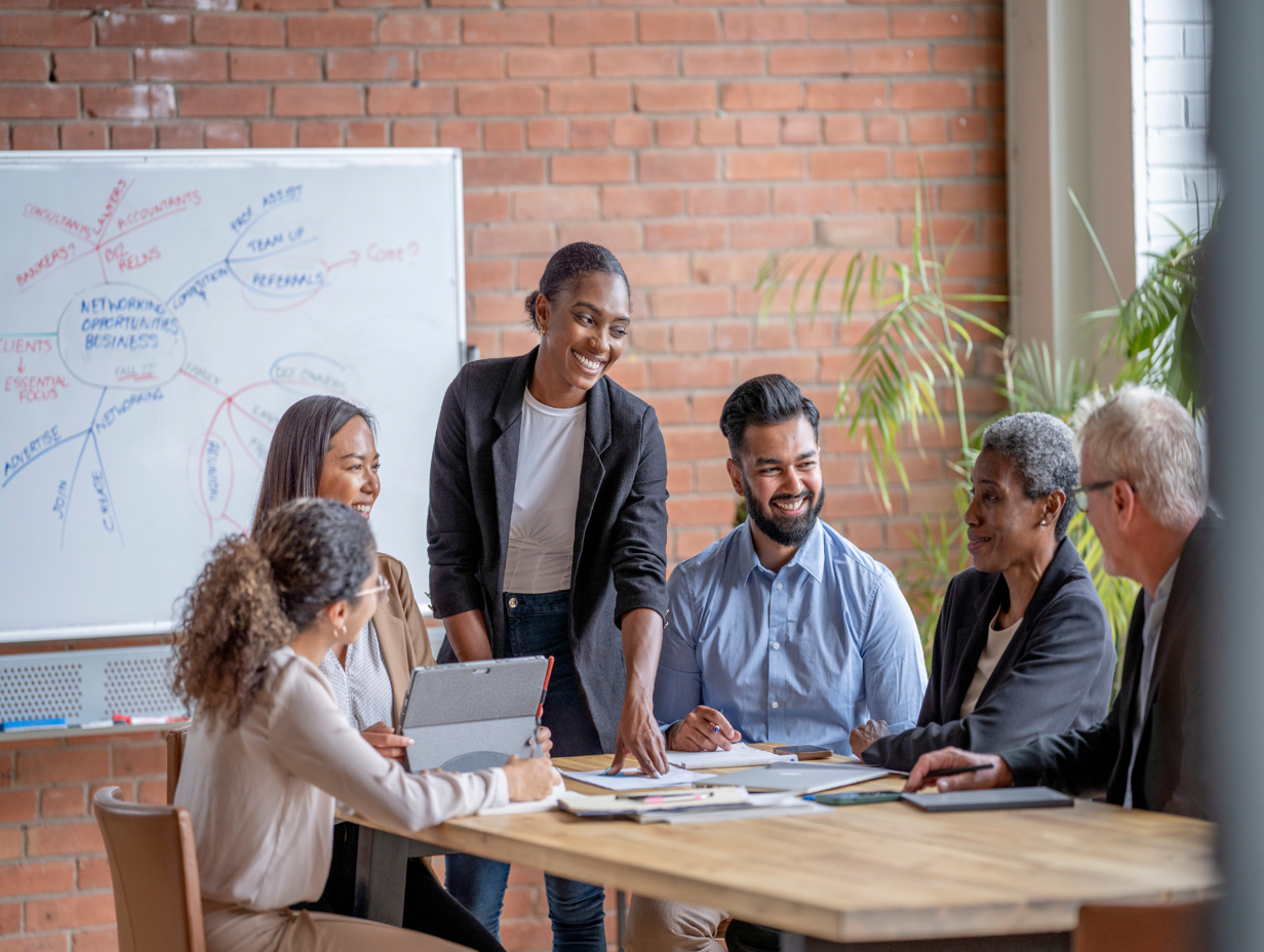 Three happy business people discussing strategy