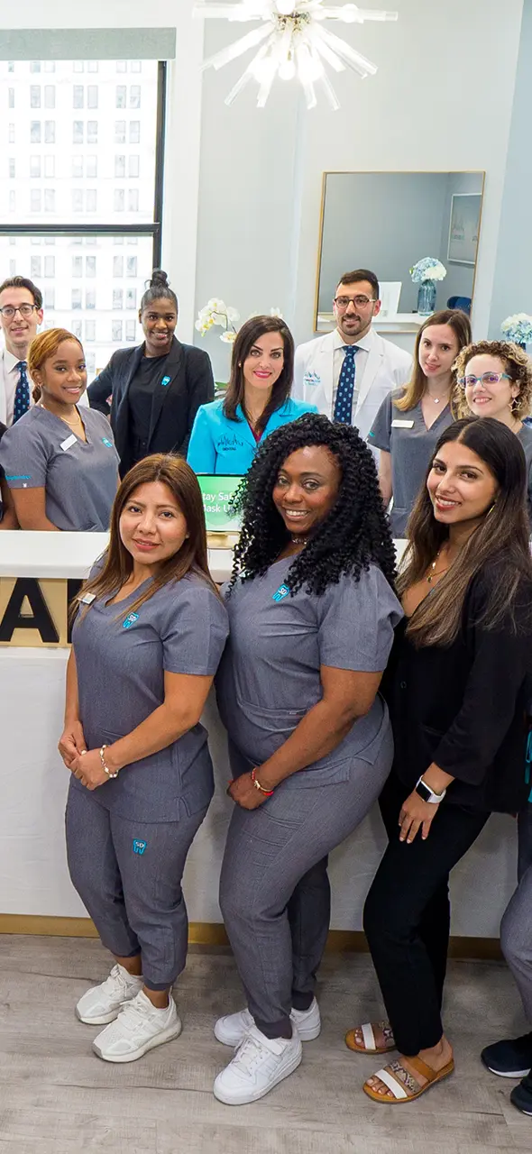 Entire staff at the front desk smiling