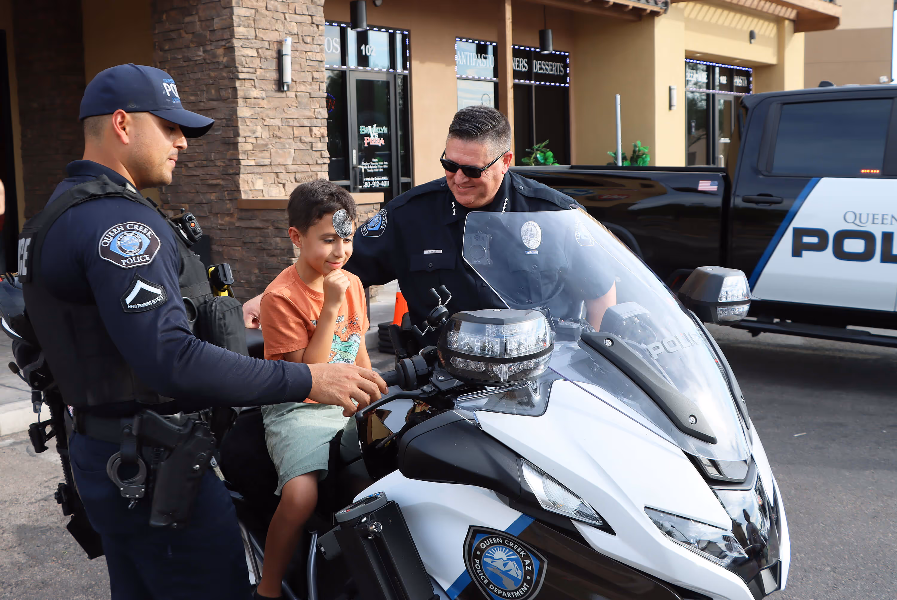 2 officers with a child on the motorcycle