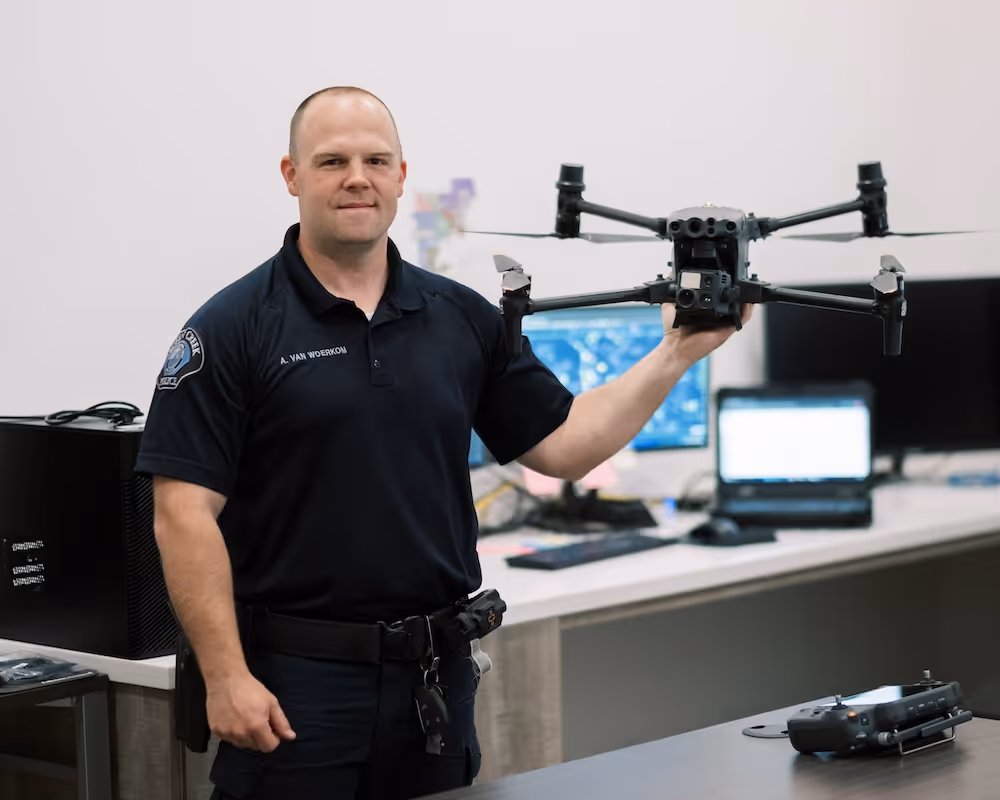 male officer holding a drone