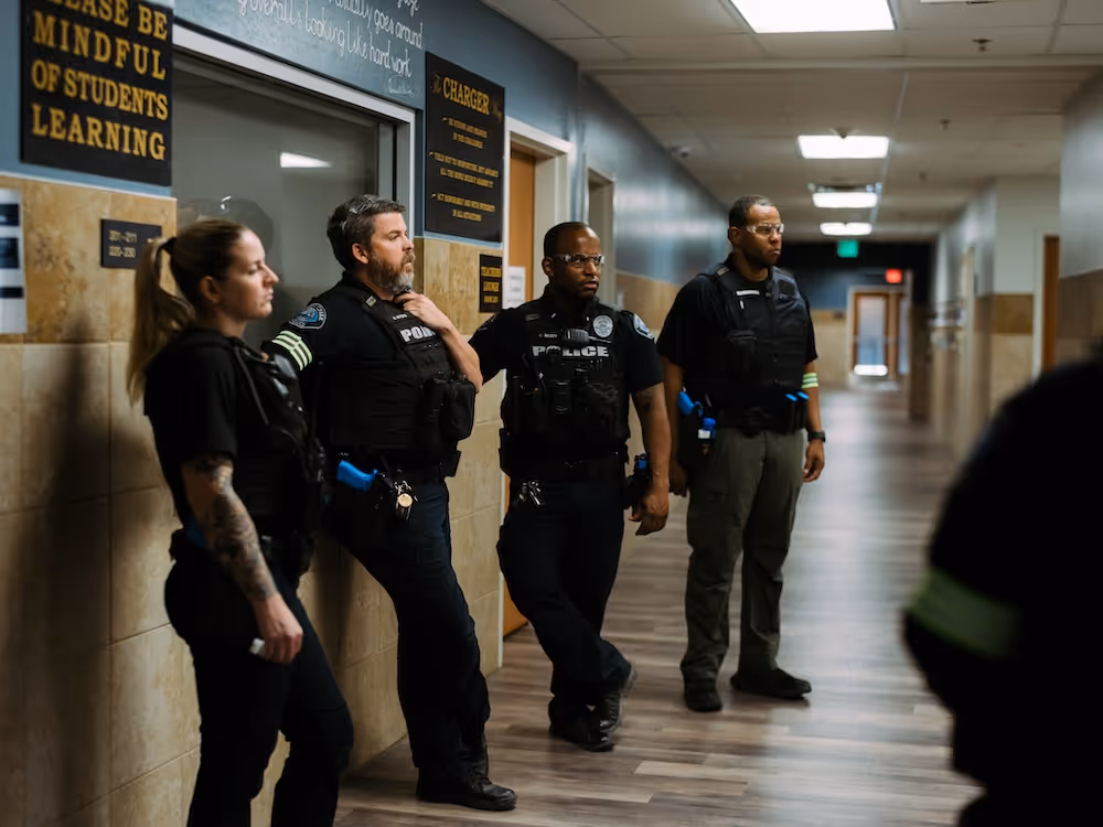 4 officers in the hallway