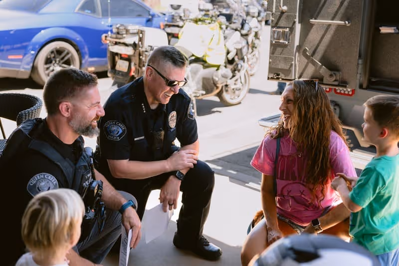 2 male officers talking to children
