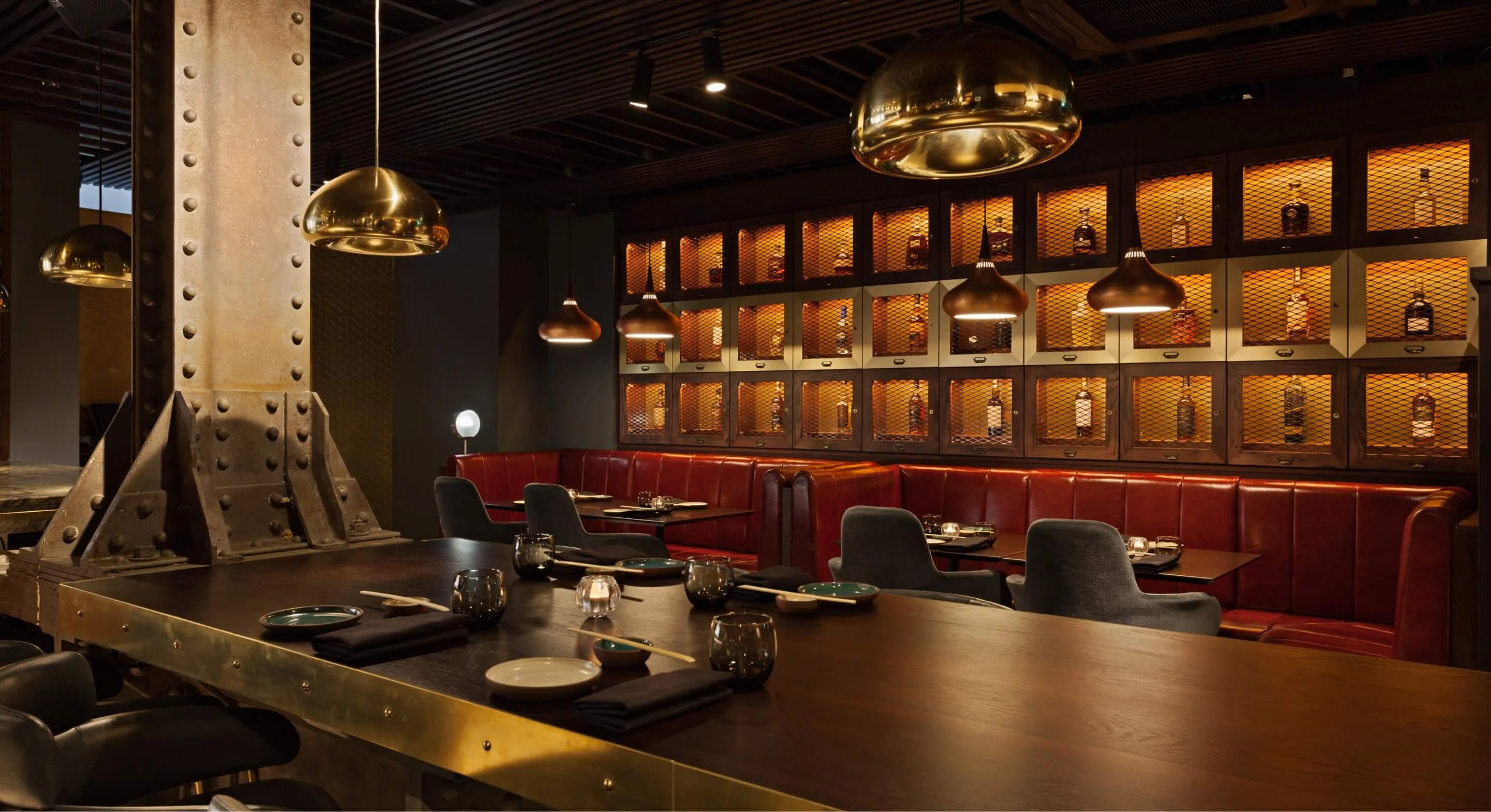 Interior of restaurant with spacious bar and wooden tables.