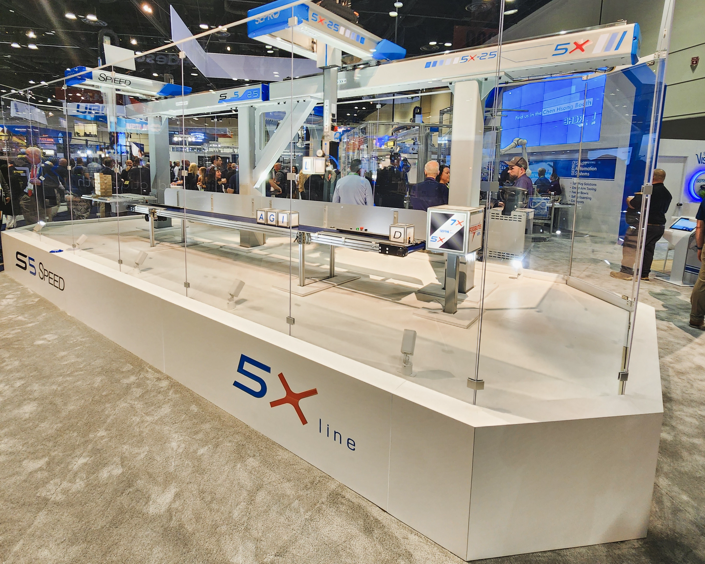large riser display surrounded by acrylic panels for Sepro to showcase one of their machines.