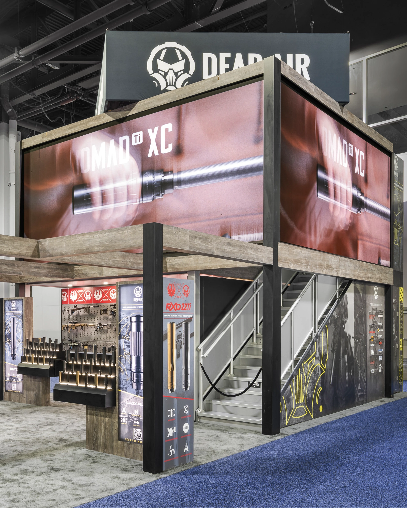 Front right view of the Dead Air booth at NRA show.  Large booth with a deck and large LED video panels on three sides on the second floor exterior.
