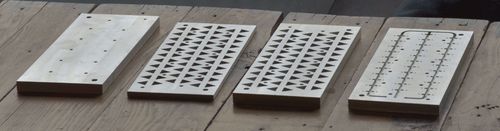 Aluminum mold parts sitting on table