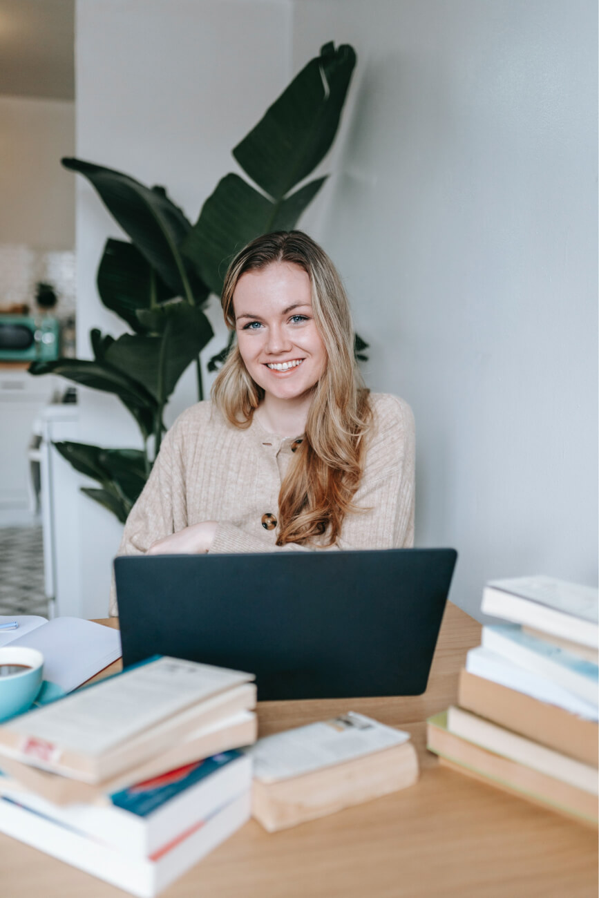 A portrait of a young professional woman at her desk