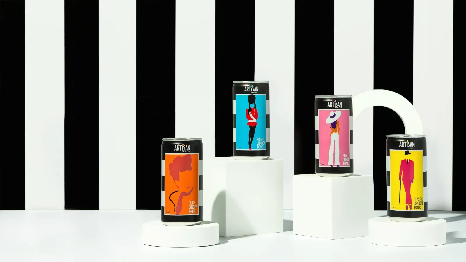 Four colorful artisan drink cans on white podiums against a black and white striped background.