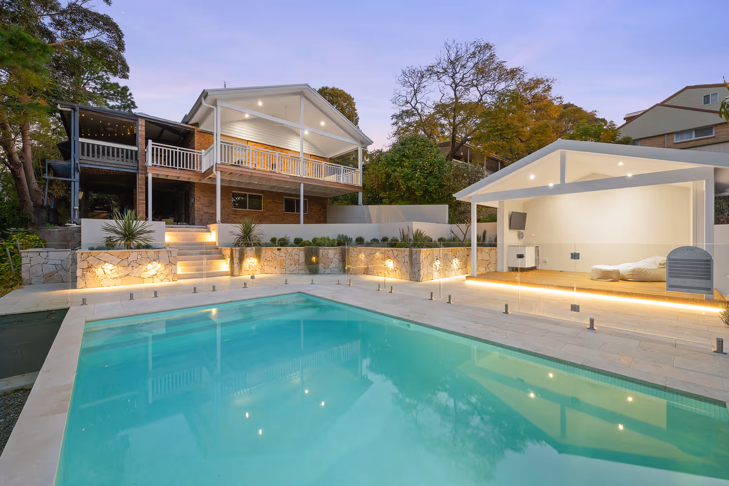 A swimming pool in front of a house