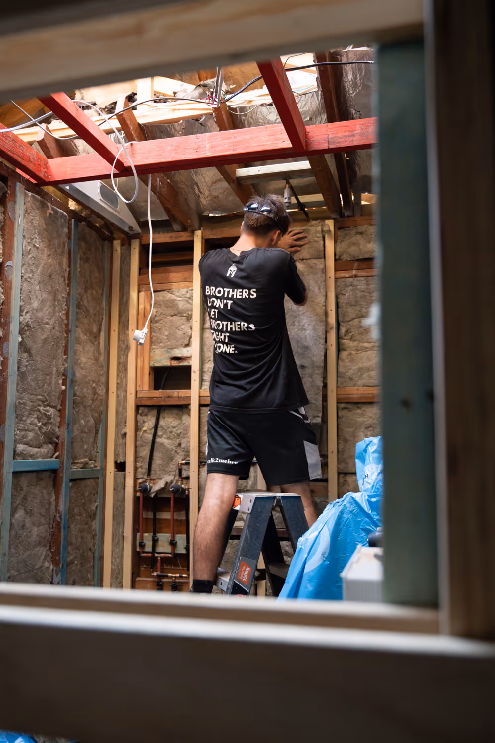 A man nailing a wall