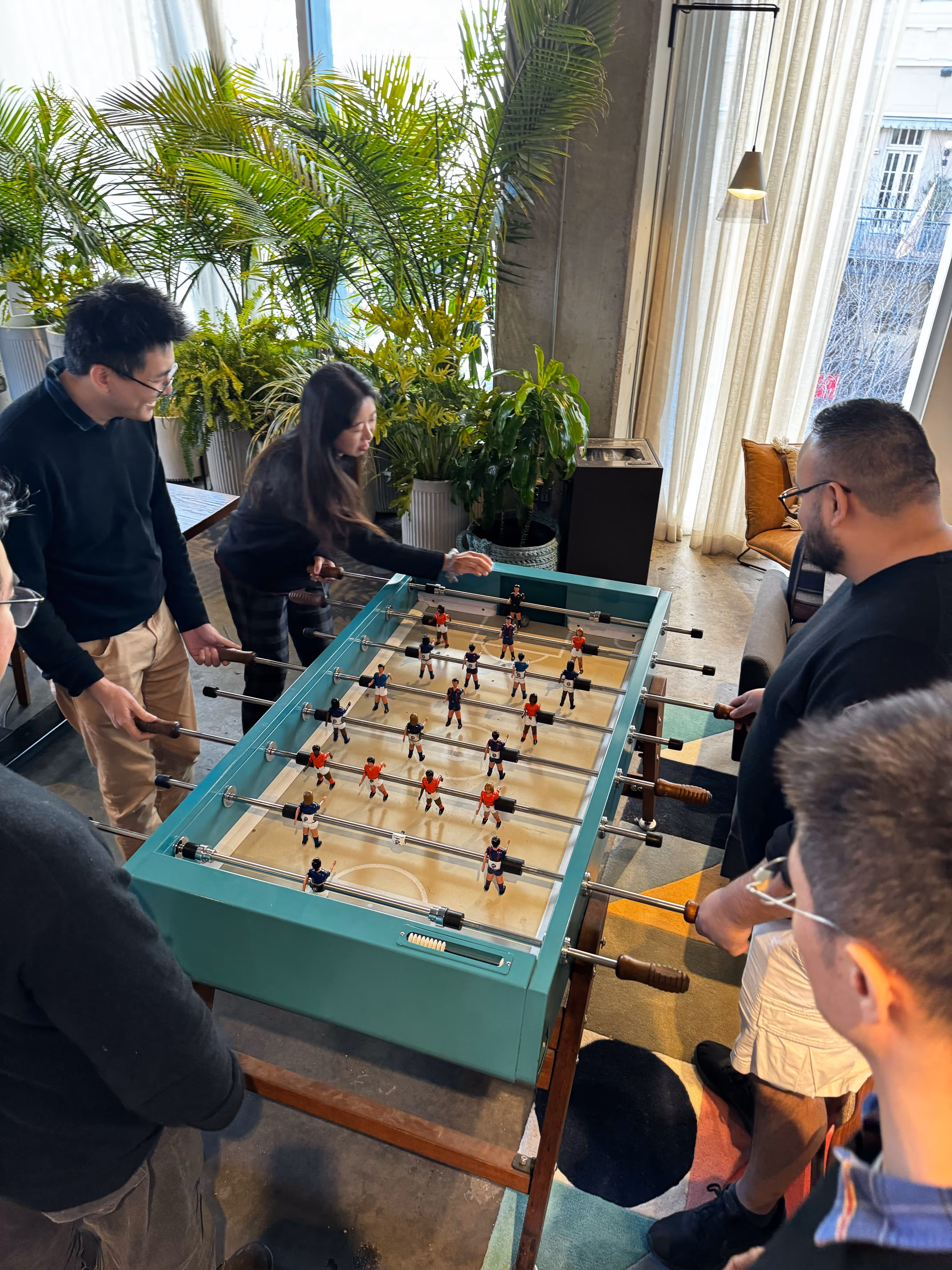 Verdigris team members enjoy a game of foosball
