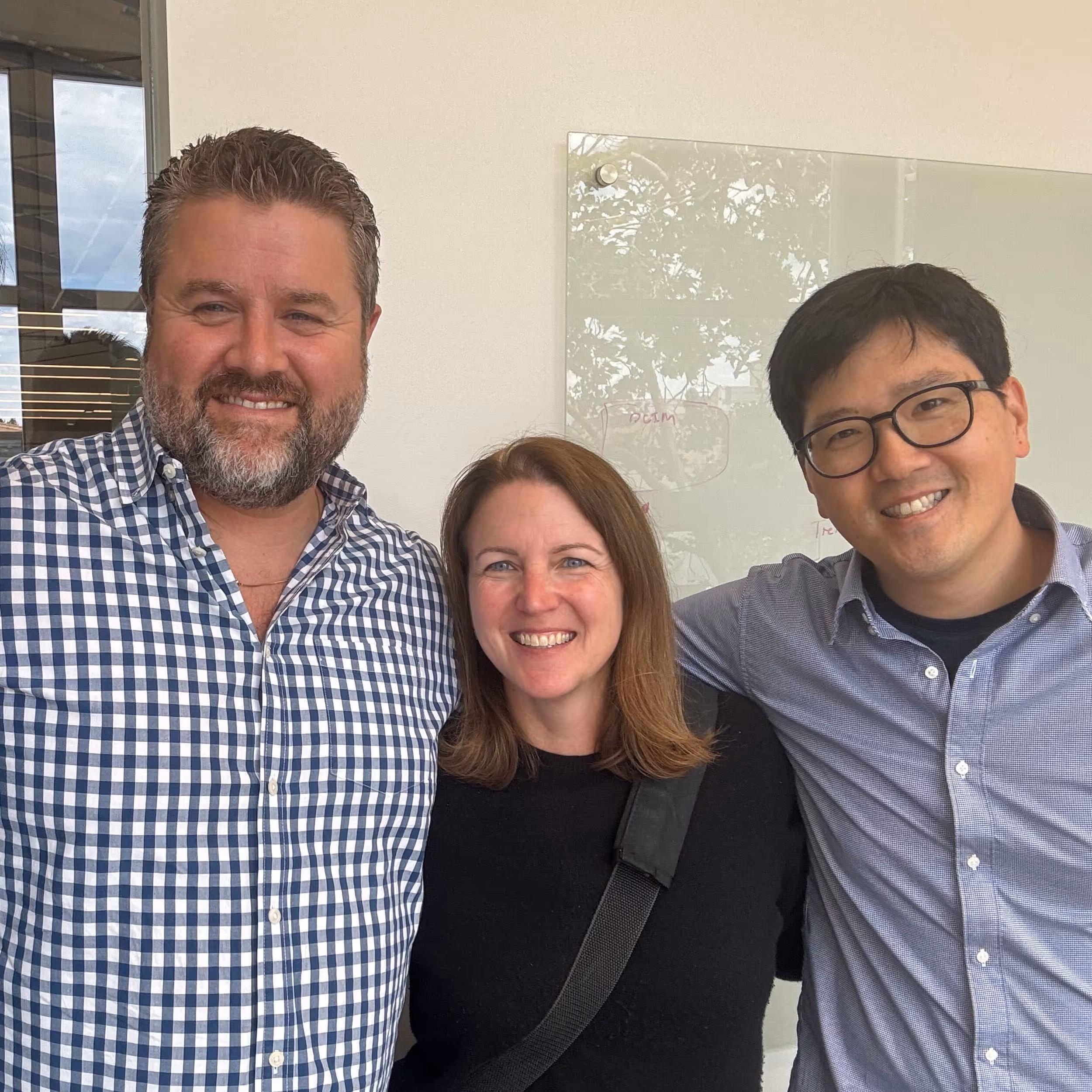 Three Verdigris team members stand smiling