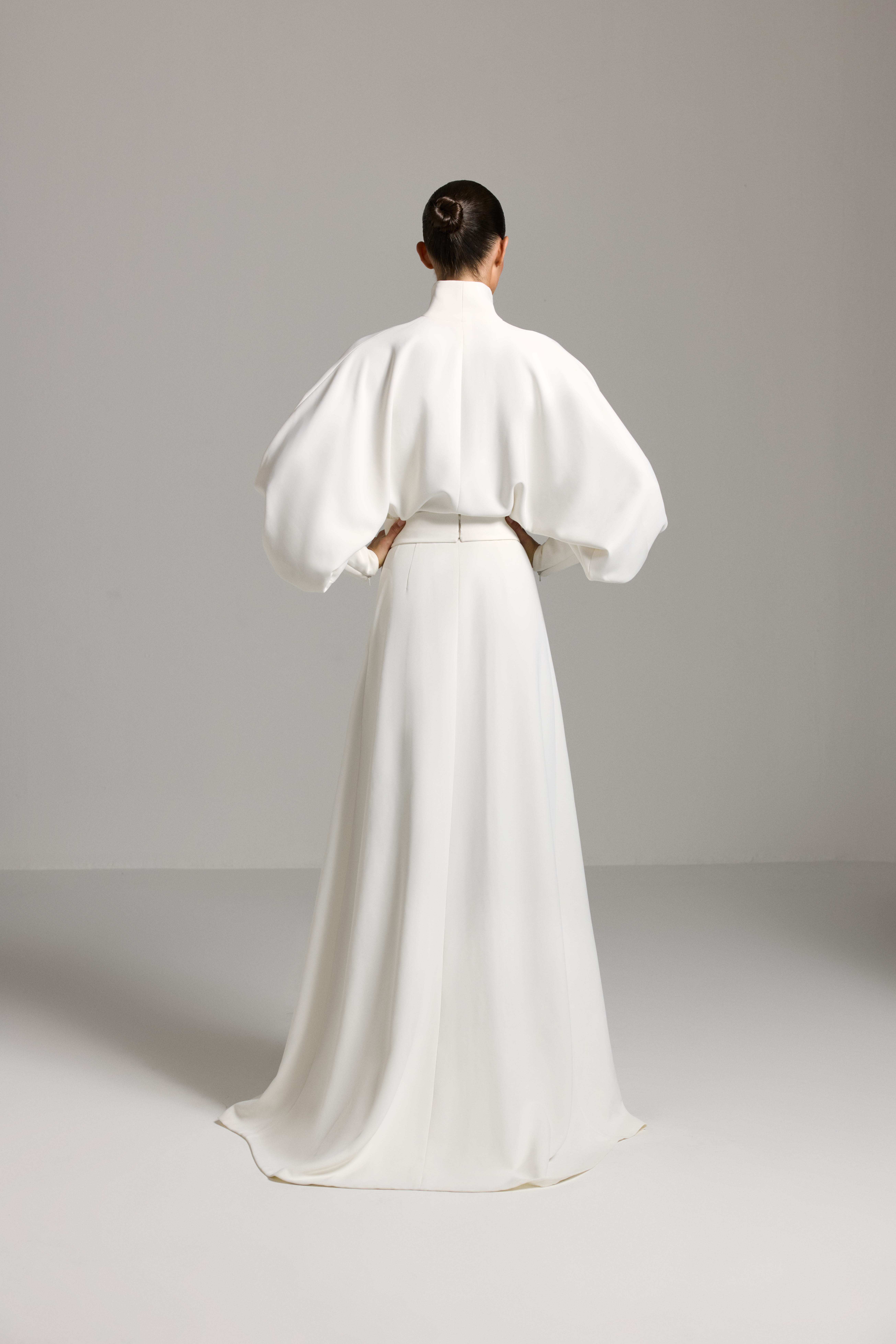 White dress AES2026P0025- A maxi-length dress with long sleeves and a defined waist - ADAMARIS - the international brand 