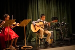 Guitar lessons for kids at Angeles Academy are a worthwhile investment into their future