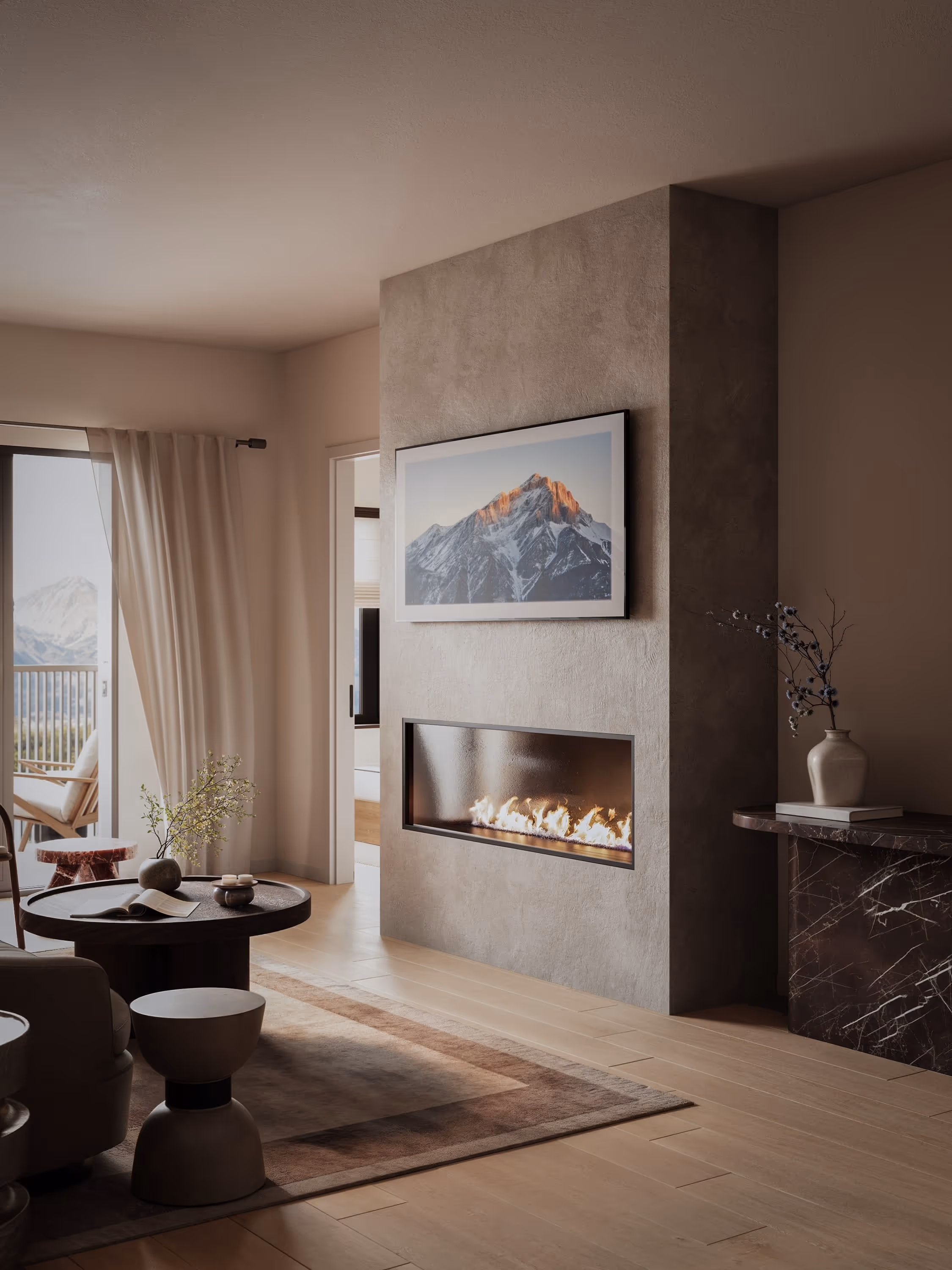 A bright and inviting living room with large windows overlooking the mountains. The decor includes a comfortable sofa, a coffee table, and tasteful artwork, making it a perfect space for relaxation.