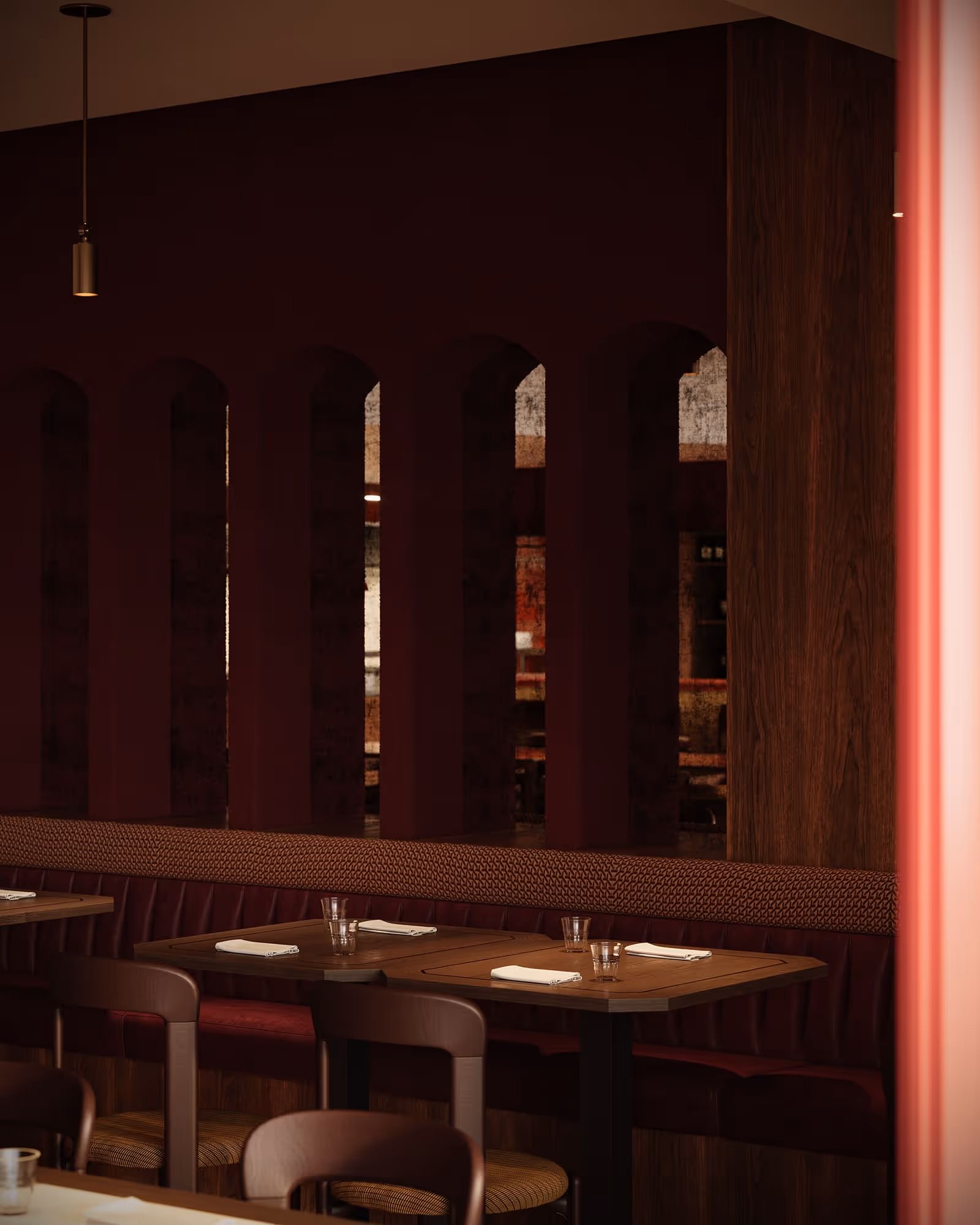 An arched entrance featuring elegant decor and a well-lit atmosphere, enhancing the inviting character of the bar. The design combines modern and classic elements seamlessly.