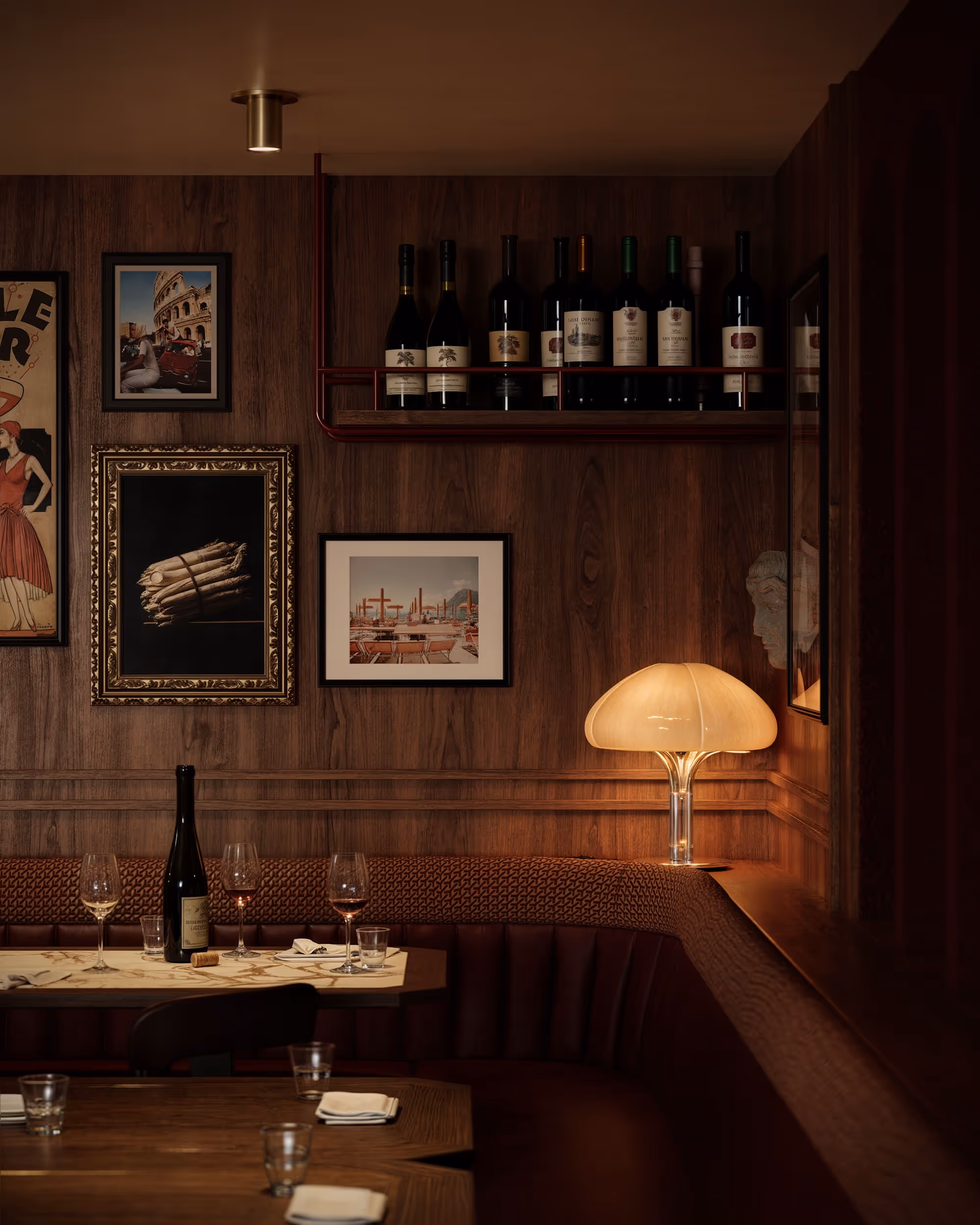 A close-up view of a cozy corner in the bar area, featuring plush seating and decorative elements that invite relaxation. The dim lighting and rich textures add to the intimate atmosphere.