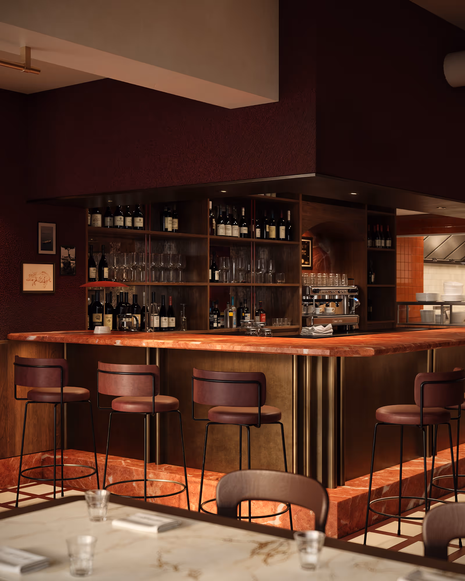 A bar interior featuring a polished bar top made of rich marble, surrounded by elegant high stools. The backdrop includes a well-stocked shelf of wine bottles, complemented by warm lighting that creates an inviting atmosphere.