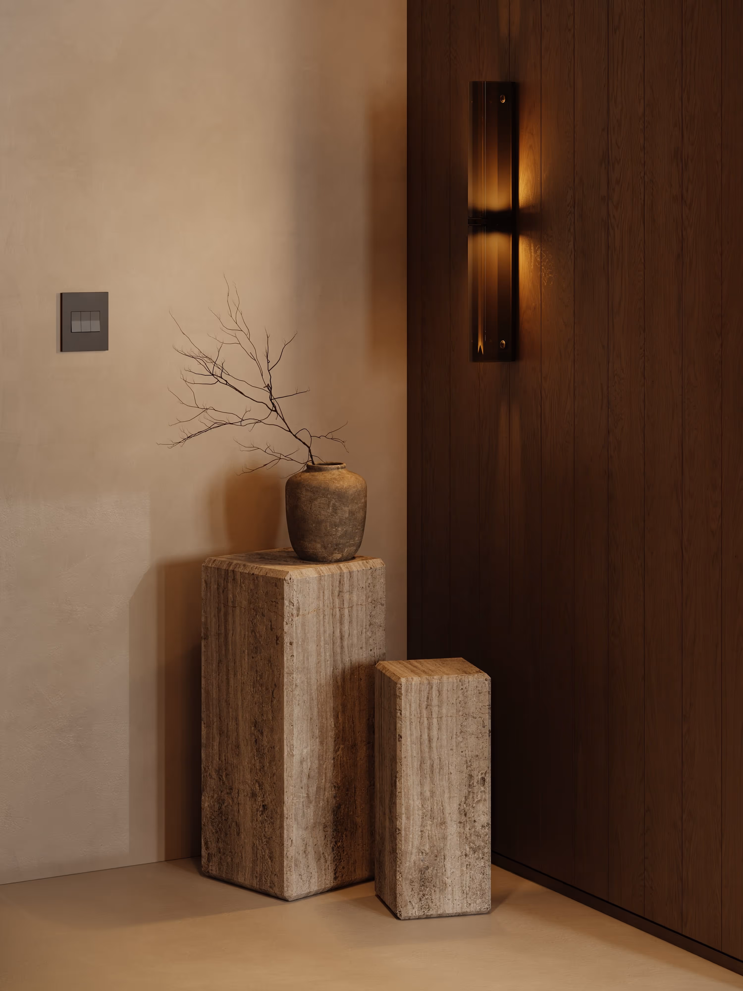 A decorative corner with natural wood accents and textured stone pedestals, softened by warm lighting. The arrangement evokes a sense of balance and tranquility within the office environment.