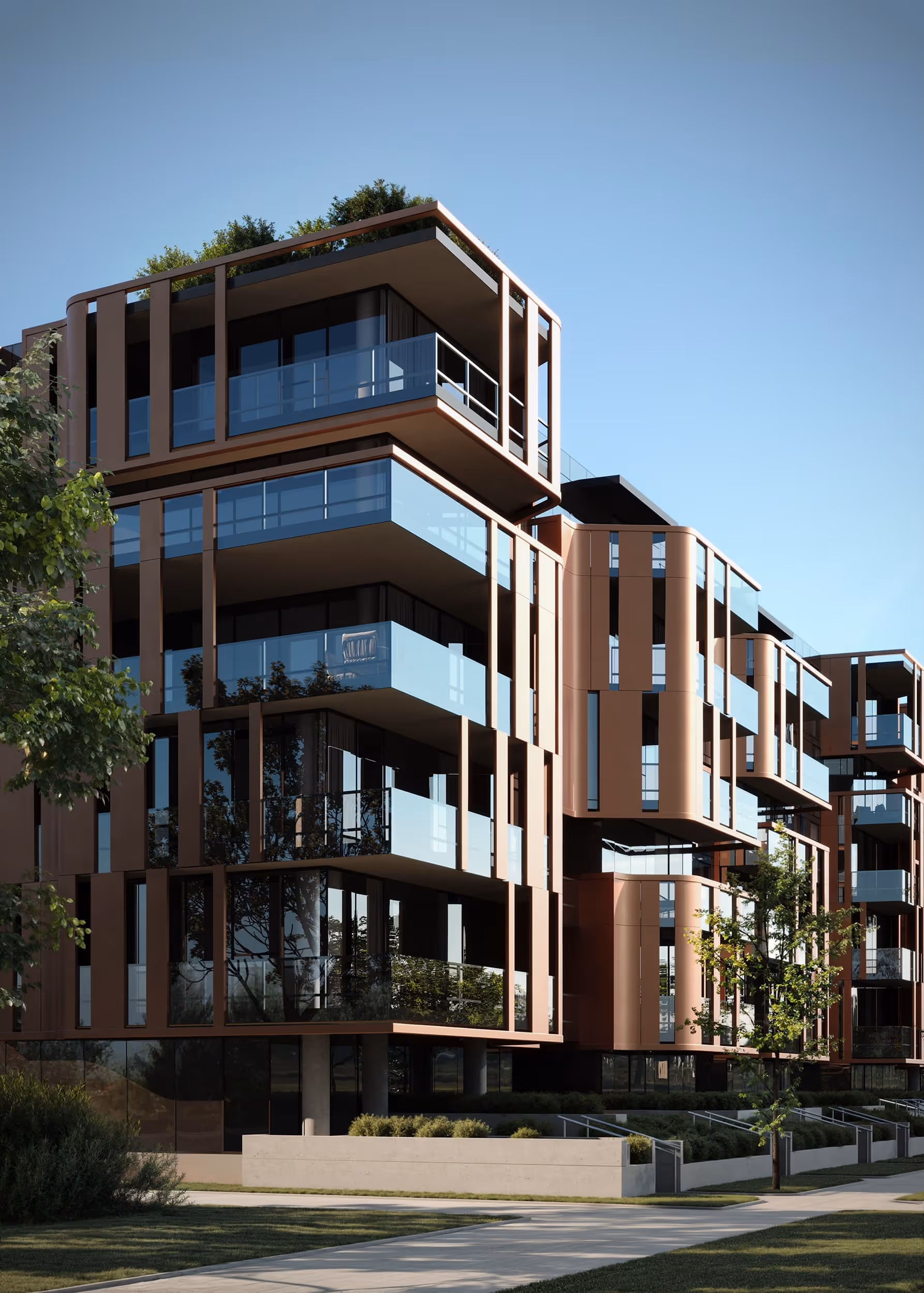 A close-up view of the modern building’s facade, highlighting glass balconies, copper accents, and sleek architectural lines.