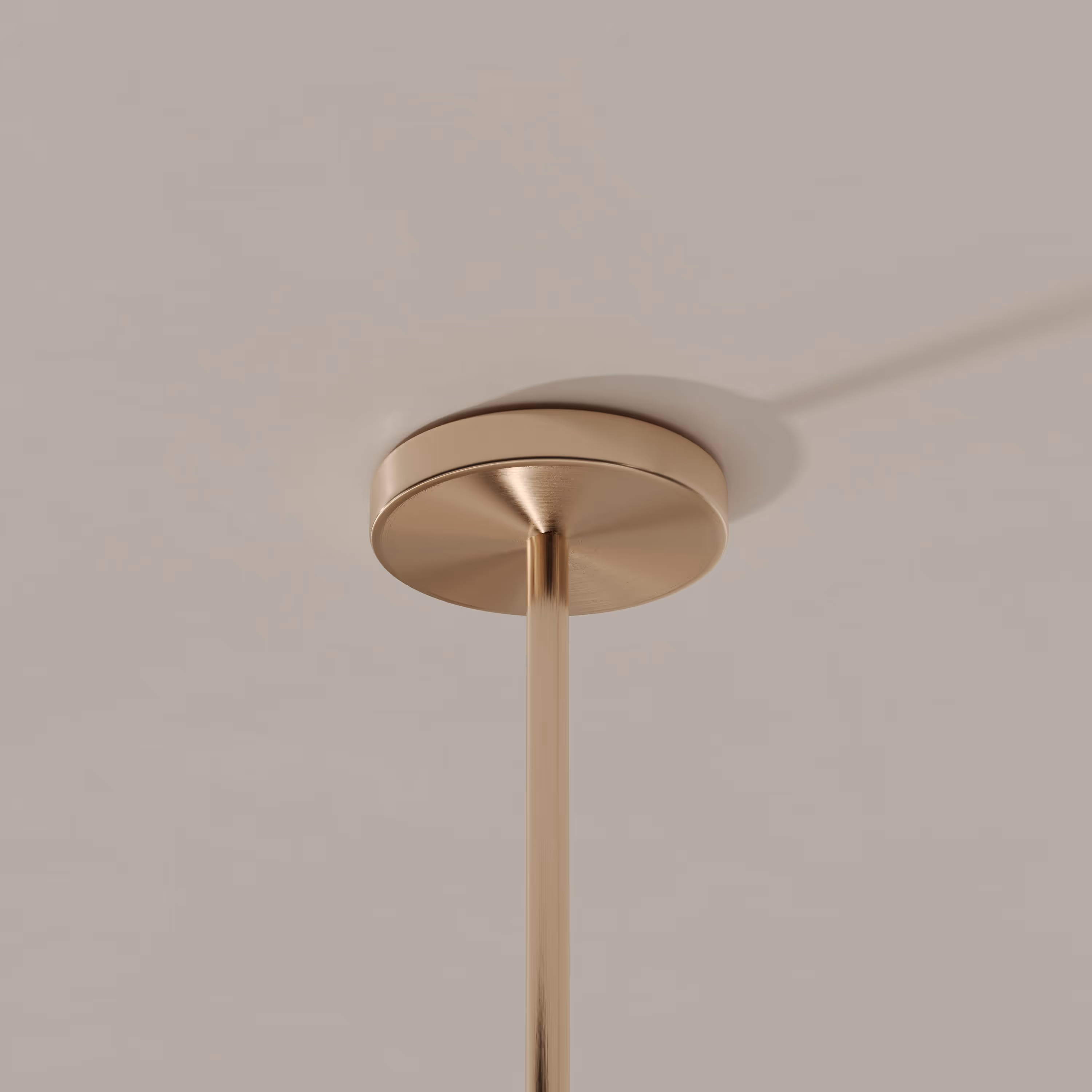 Close-up of a sleek, brushed metal ceiling fixture attachment for a suspended light, featuring simple and modern design elements.