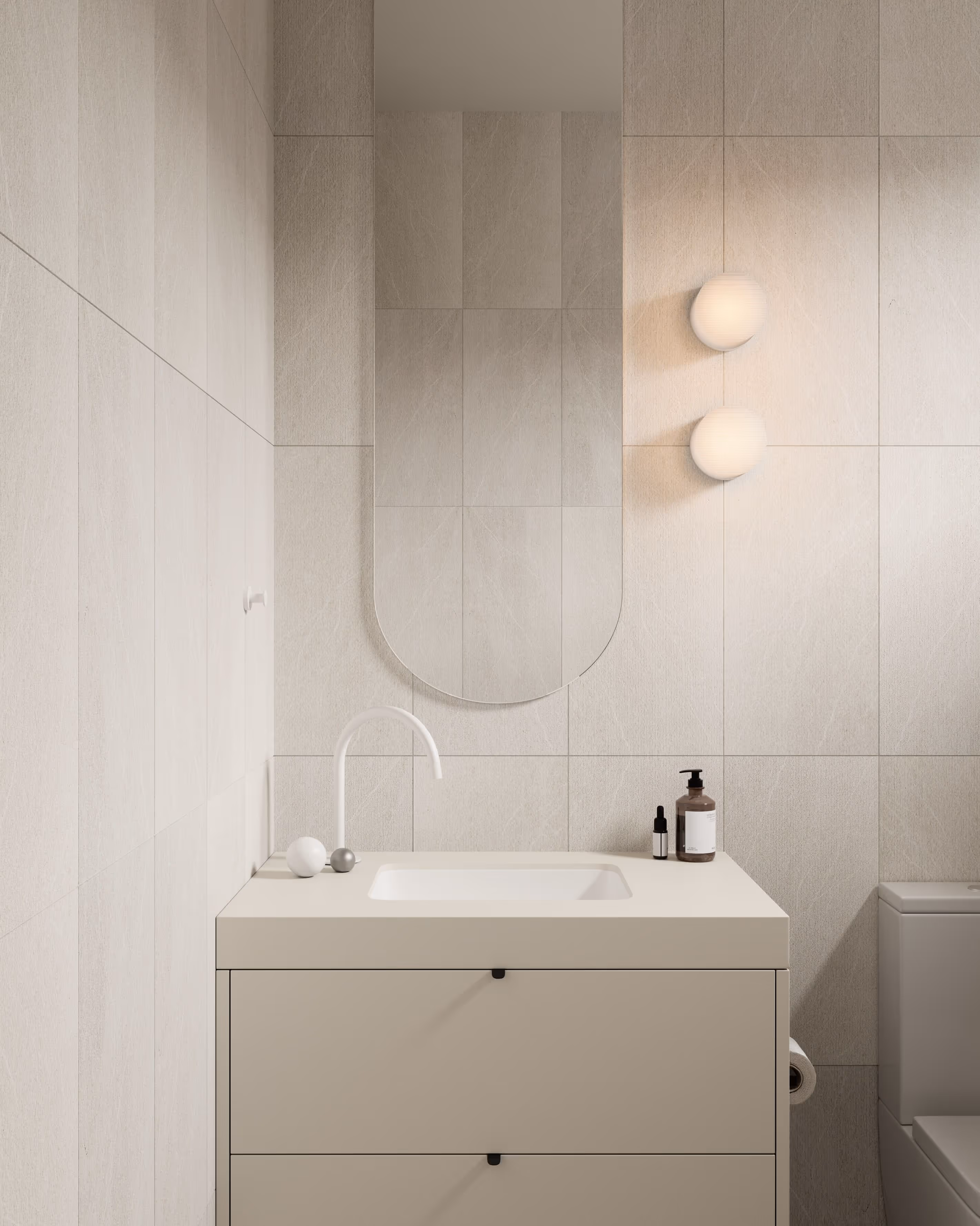 Modern bathroom with beige tiled walls, minimalist vanity, and a round mirror