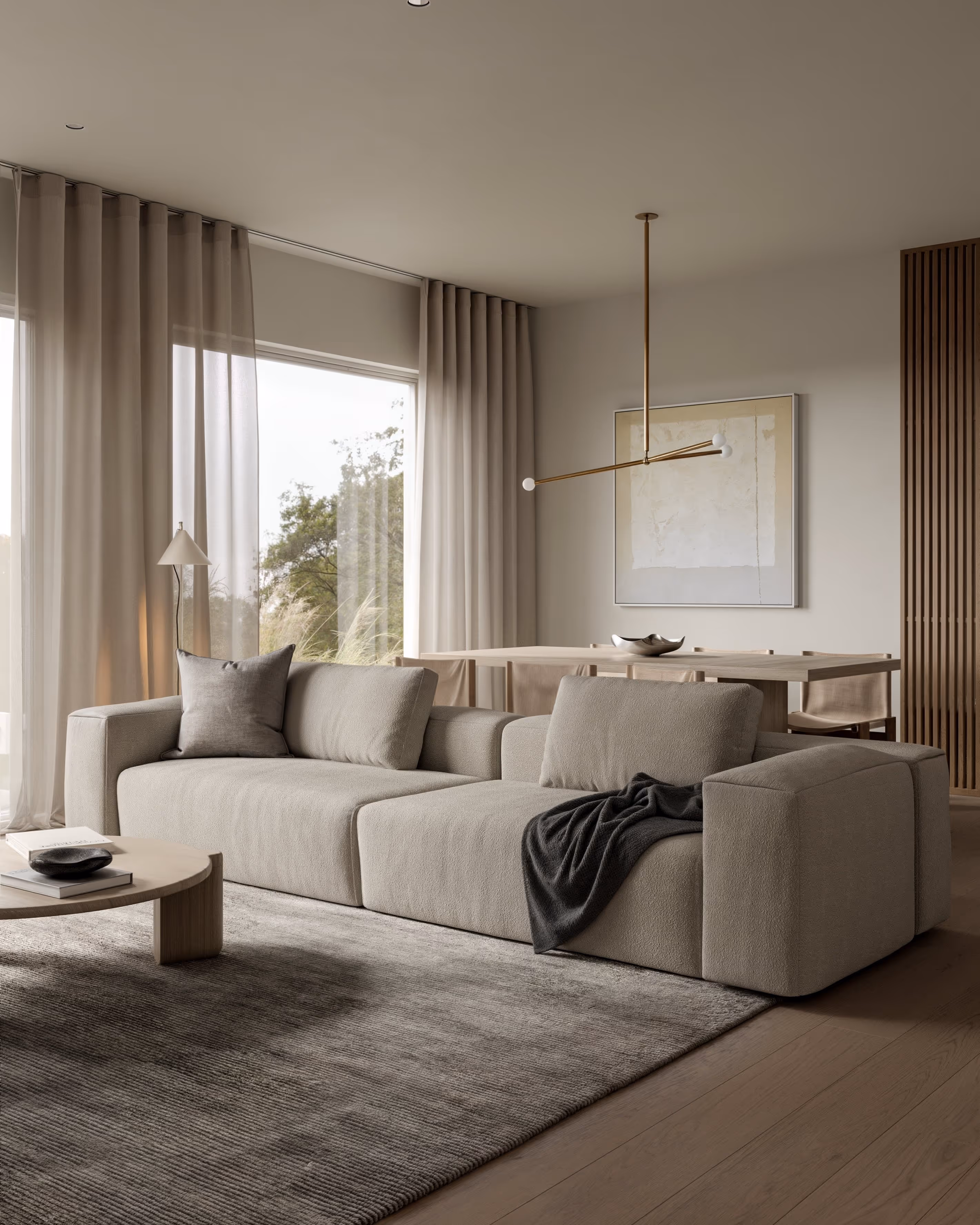 Cozy living room with a light gray sectional sofa, wooden coffee table, and floor-to-ceiling windows
