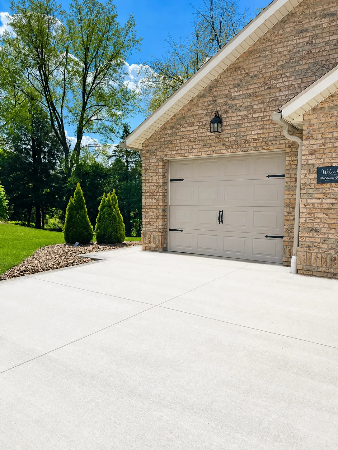 brick home with concrete driveway
