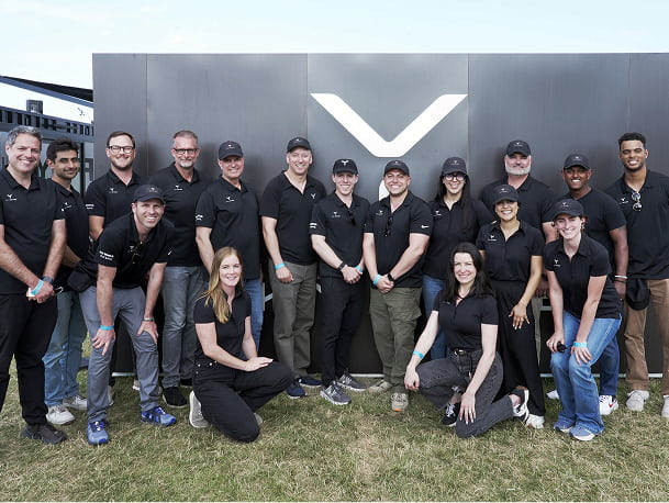 A group photo in front of the Skyryse logo - all wearing black t-shirts