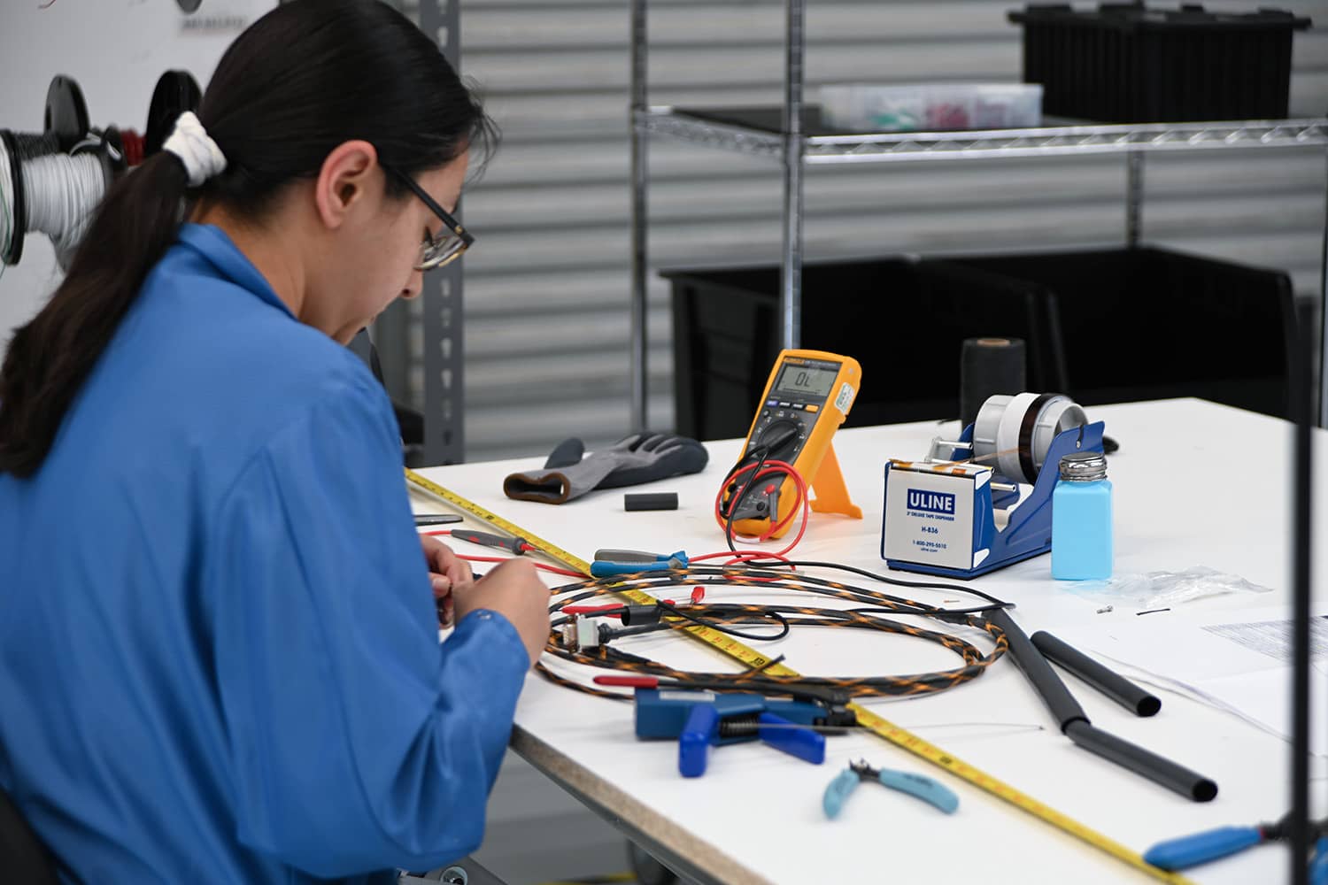 Woman soldering electronic parts on a table
