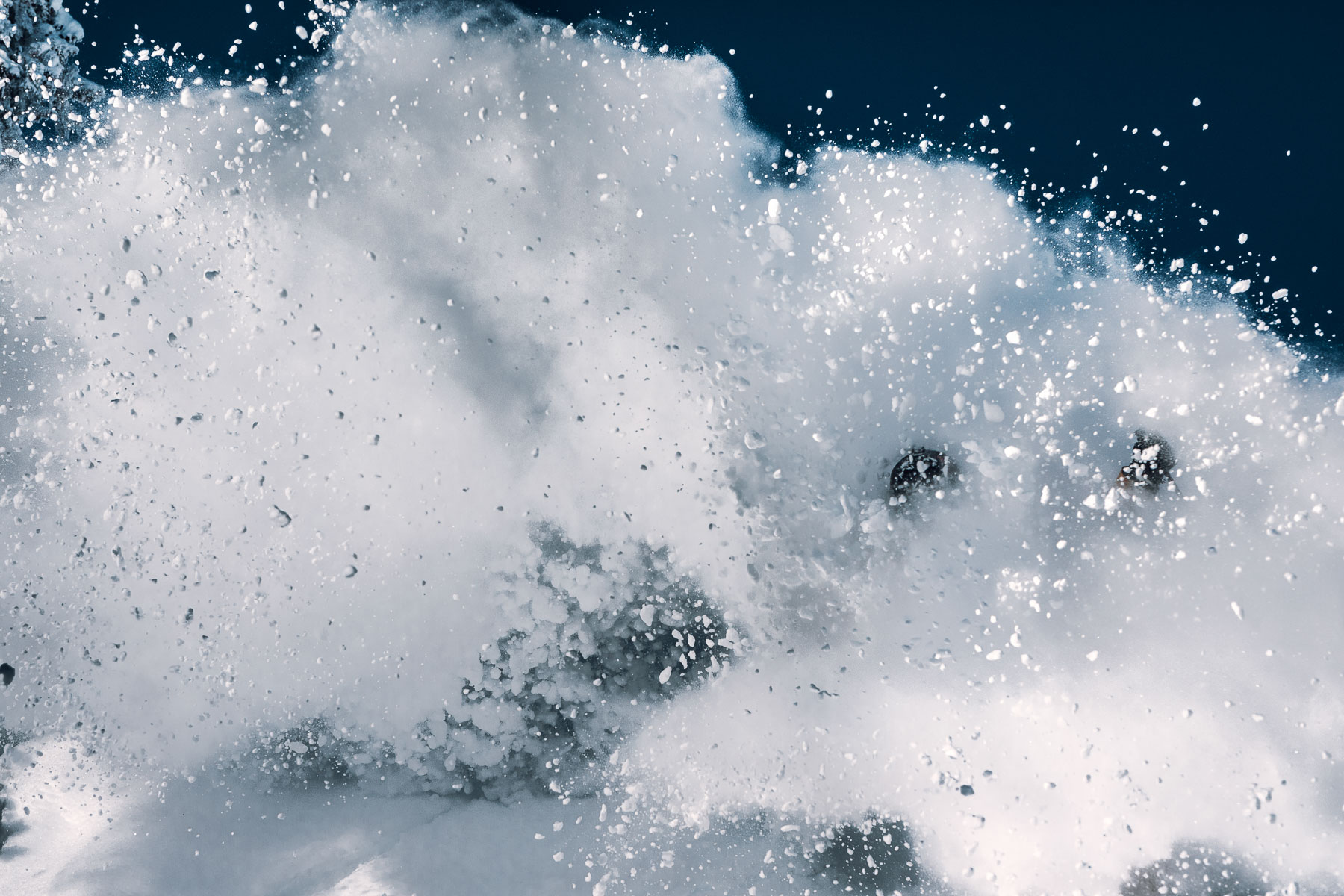 Skier surrounded by a cloud of powder snow