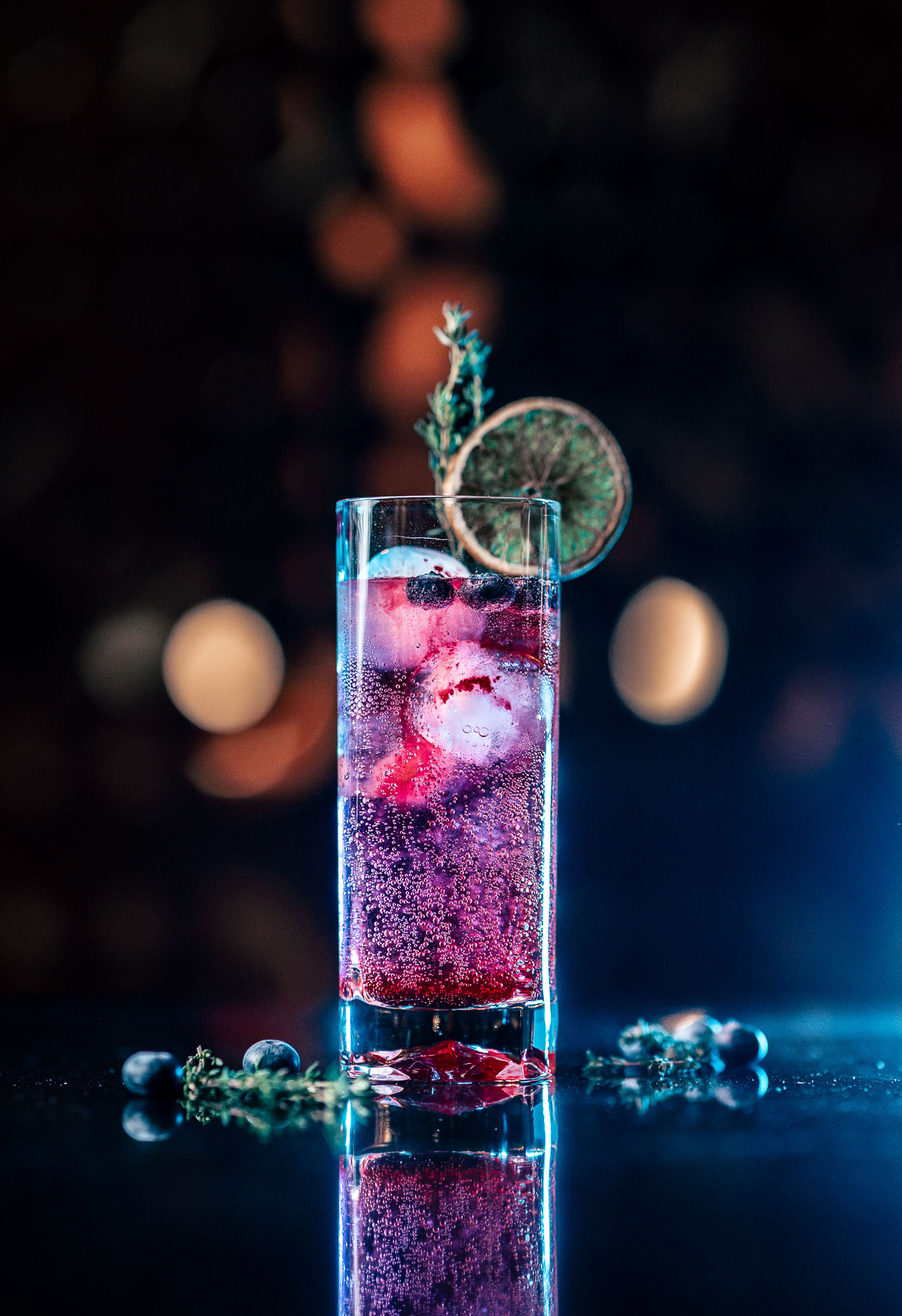 Berry cocktail with citrus and herb garnish at Mica Heli-Skiing lodge