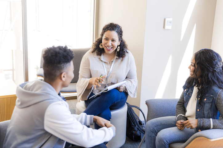 Happy female high school student studying online with Enlightium Academy