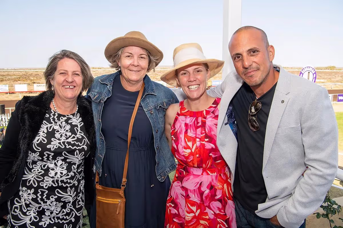 people standing in front of race course smiling